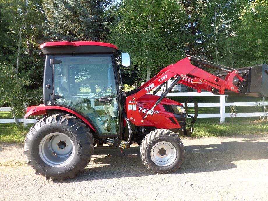 New TYM T-474 has 47 HP sports the Kukje Direct injection 4 Cylinder Diesel engine -4x4 on demand - heat and air cab- quick attach bucket - easy remove loader, Cat# 1 3 point with rear Control, 